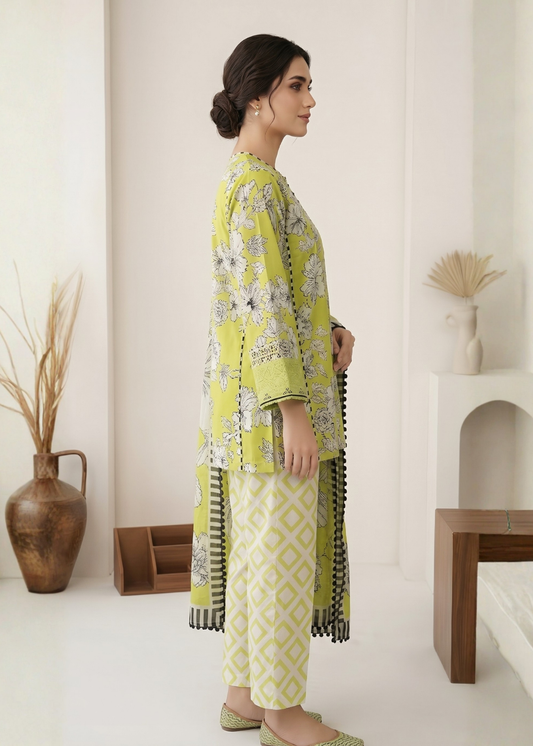 Woman wearing a green and white floral outfit in a minimalistic room.