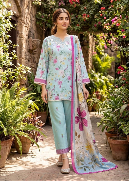 Woman in a floral dress standing in a garden with flowers and plants around.