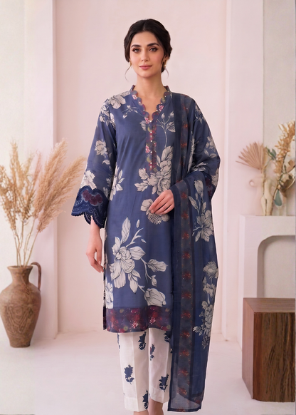 Woman wearing a blue floral dress with white pants in a minimalistic setting.