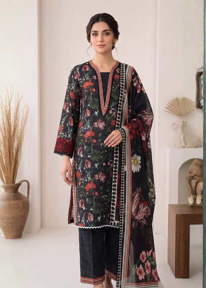 Woman wearing a floral dress with a matching dupatta in a minimalistic room.