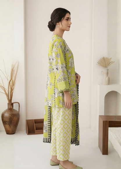 Woman wearing a green and white floral outfit in a minimalistic room.