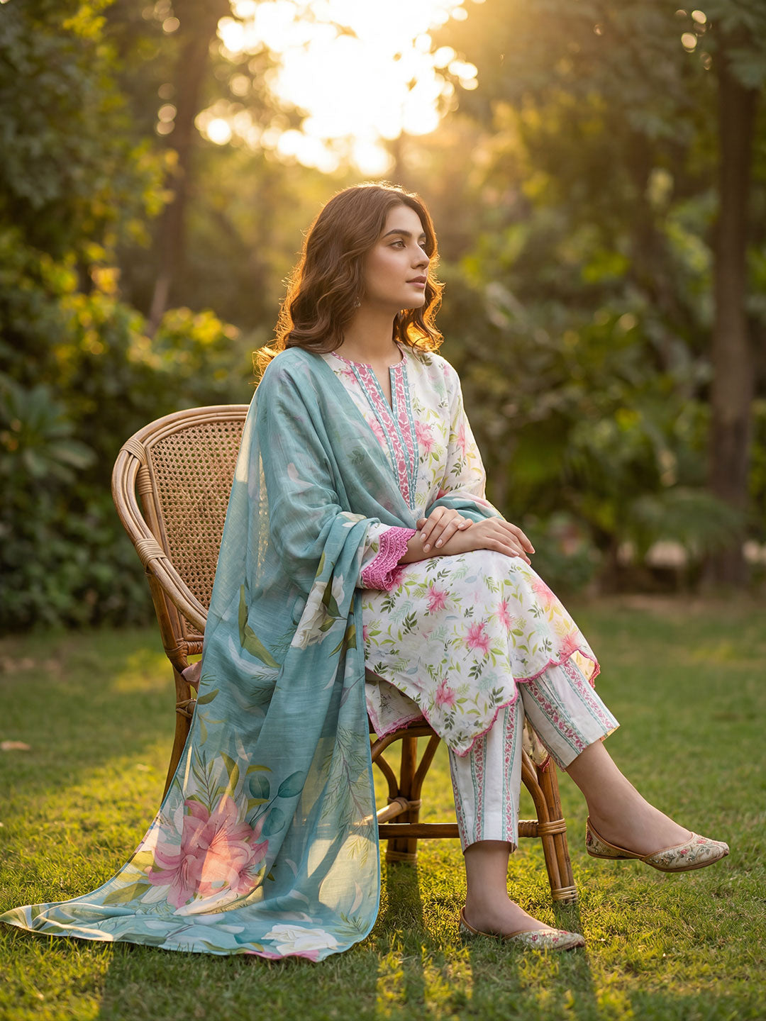 Woman in a floral outfit sitting on a chair in a garden