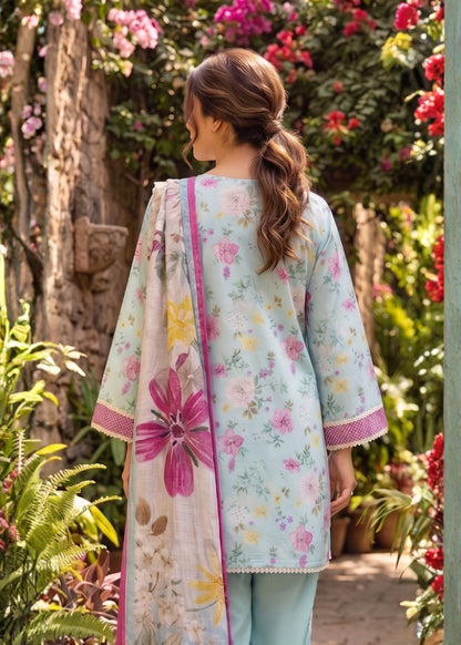 Woman wearing a floral dress and dupatta in a garden setting