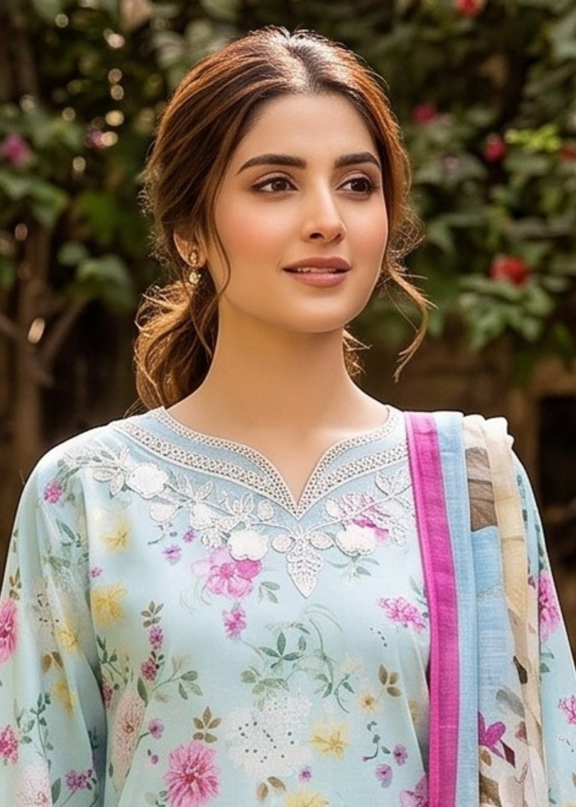 Woman wearing a floral saree with a blurred natural background